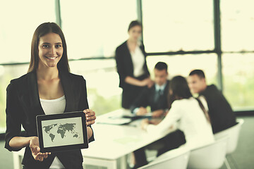 Image showing business woman with her staff in background at office