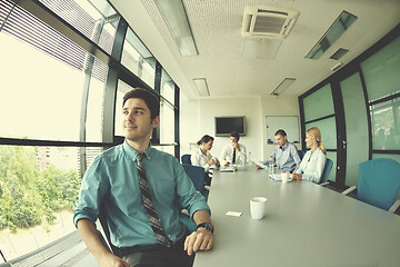 Image showing business man  on a meeting in offce with colleagues in backgroun