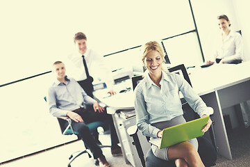 Image showing business woman with her staff in background at office