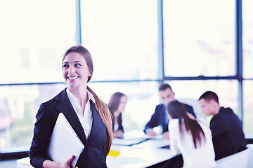 Image showing business woman with her staff in background at office