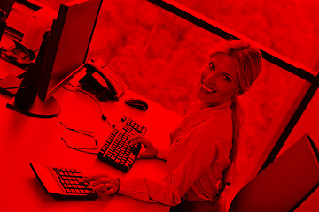 Image showing Young pretty business woman with notebook in the office