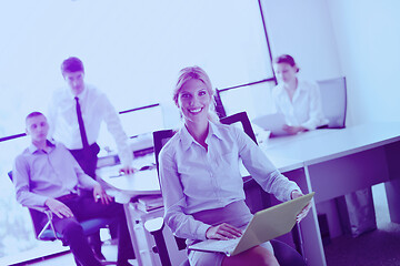 Image showing business woman with her staff in background at office