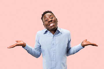 Image showing The happy businessman standing and smiling against pink background.