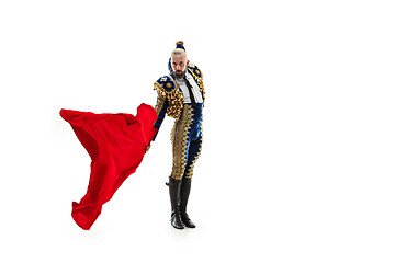 Image showing Torero in blue and gold suit or typical spanish bullfighter isolated over white