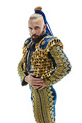 Image showing Torero in blue and gold suit or typical spanish bullfighter isolated over white