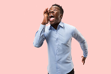 Image showing Isolated on pink young casual man shouting at studio