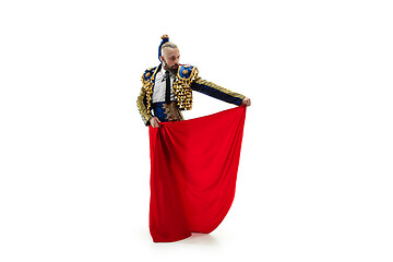 Image showing Torero in blue and gold suit or typical spanish bullfighter isolated over white