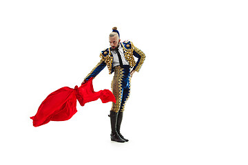 Image showing Torero in blue and gold suit or typical spanish bullfighter isolated over white