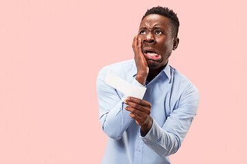 Image showing Young boy with a surprised expression bet slip on blue background