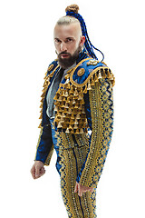 Image showing Torero in blue and gold suit or typical spanish bullfighter isolated over white