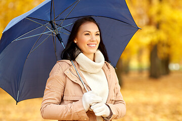 Image showing happy woman with umbrella in autumn park