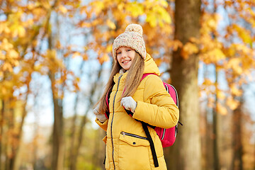 Image showing happy student girl with schoolbag at autumn park