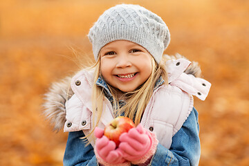 Image showing portrait of happy little girl with apple in autumn