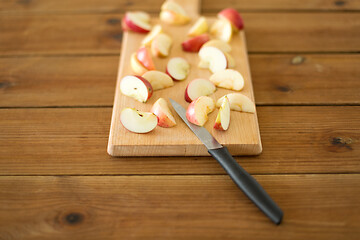 Image showing sliced apples and knife on wooden cutting board