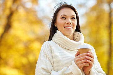 Image showing woman drinking takeaway coffee in autumn park