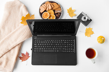 Image showing laptop, tea, camera, autumn leaves and sweater