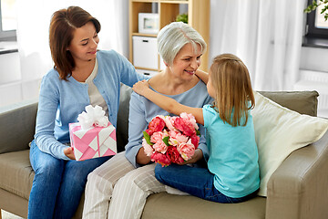 Image showing granddaughter hugging and greeting grandmother