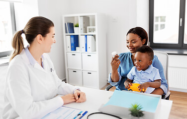 Image showing doctor and woman with baby and medicine at clinic