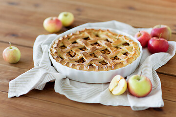 Image showing apple pie in baking mold on wooden table