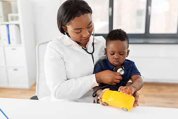 Image showing doctor with stethoscope and baby patient at clinic