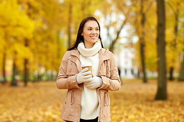 Image showing woman drinking takeaway coffee in autumn park