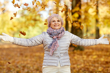 Image showing happy senior woman enjoying beautiful autumn