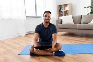 Image showing indian man with tablet pc and exercise mat at home