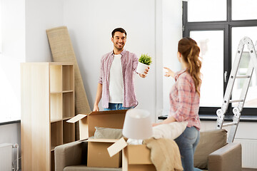 Image showing happy couple with stuff moving to new home