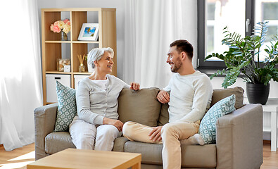 Image showing senior mother talking to adult son at home