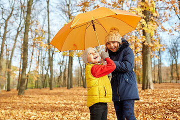 Image showing happy children with umbrella at autumn park