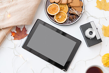 Image showing tablet computer, camera, autumn leaves and garland