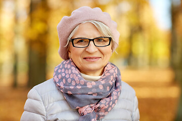 Image showing portrait of happy senior woman at autumn park