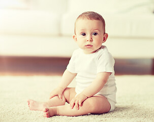 Image showing happy baby boy or girl sitting on floor at home