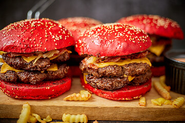 Image showing Burgers and french fries on board