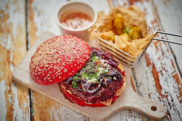 Image showing Vegetarian burger on cutting board