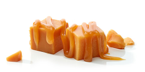 Image showing caramel candies with melted caramel sauce