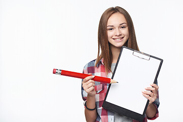 Image showing Girl holding big pencil and blank paper sheet