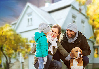 Image showing happy family with dog over house in autumn