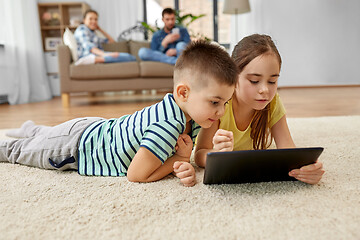 Image showing brother and sister with tablet computer at home