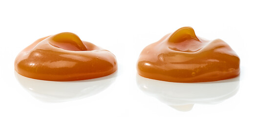 Image showing melted caramel on white background