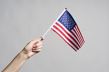 Image showing Human hand holding USA flag