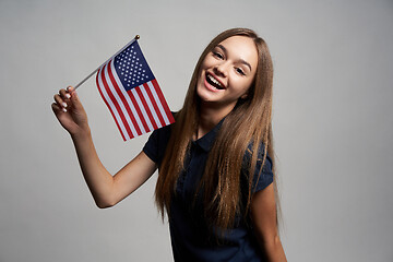 Image showing Happy female holding USA flag