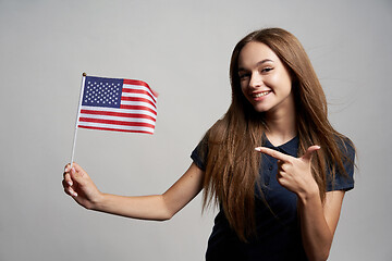 Image showing Happy female holding USA flag