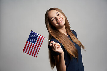 Image showing Happy female holding USA flag