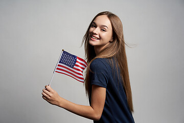 Image showing Happy female holding USA flag