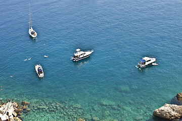 Image showing View of the Tremiti Islands. Boats near a rock stone coast.