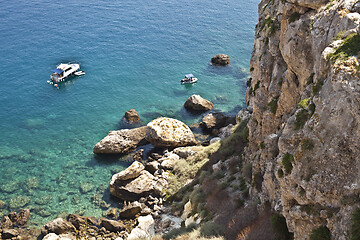 Image showing View of the Tremiti Islands. Boats near a rock stone coast.