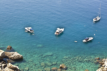 Image showing View of the Tremiti Islands. Boats near a rock stone coast.