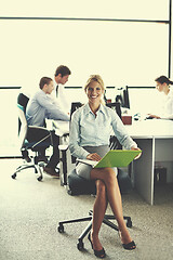 Image showing business woman with her staff in background at office