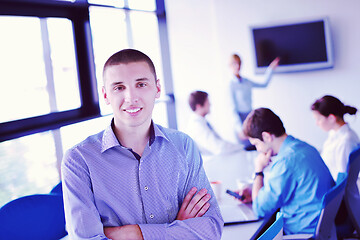 Image showing business man  on a meeting in offce with colleagues in backgroun